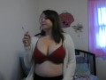 Busty girl smokes and gives a peak