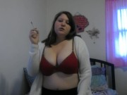 Busty girl smokes and gives a peak