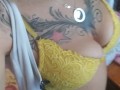 Tattooed blonde Milf unzips dress