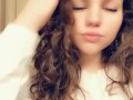 Teen with paint on her face strips for snap