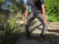 Pissing grey jeans in a huge flood outdoors