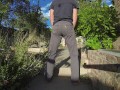Pissing grey jeans in a huge flood outdoors