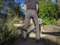 Pissing grey jeans in a huge flood outdoors