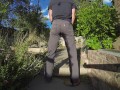 Pissing grey jeans in a huge flood outdoors