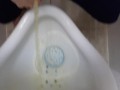 Girl Pissing Into A Urinal