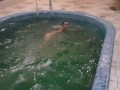 Girl jumps naked into the pool