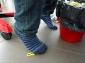 Male shoeplay and stomping stuff at home in Nikes, Vans, blue stiped socks