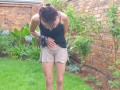 Girl pissing outside on the grass