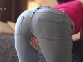 A babe in jeans shows her cool ass and jerks off her beautiful pie