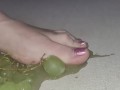 Smashing juicy grapes under my big toes close up under and side pov
