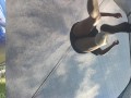 Tall girl in shorts jumping barefooted on a trampoline (slowed down) bottom view