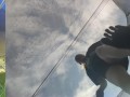Tall girl in shorts jumping barefooted on a trampoline (slowed down) bottom view