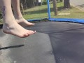 Slow motion jumping on a trampoline in shorts & T-shirt regular woman jumping not a big tit slut