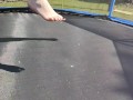 Slow motion jumping on a trampoline in shorts & T-shirt regular woman jumping not a big tit slut