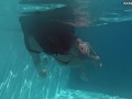 Perfect body brunette enjoys naked swimming