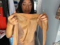 Trying on suntan pantyhose shinny leg in leather dress