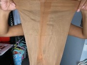 Trying on suntan pantyhose shinny leg in leather dress