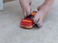Destroying a model racecar toy with my barefeet smashing it into pieces