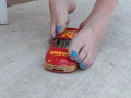 Destroying a model racecar toy with my barefeet smashing it into pieces
