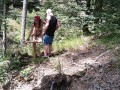 Milf woman with big tits jerking fat dick in the woods