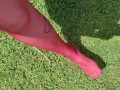 Walking around barefoot wearing red nylon stockings