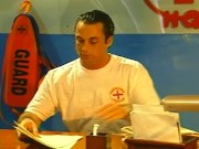 A brunette lifeguard pleases her pussy while working