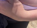 Hand expressing breastmilk at the beach!