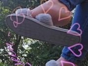 Dangling my house slippers on my toes.