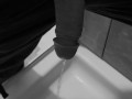Taking a quick piss on the shower floor, with my semi hard cock