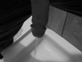 Taking a quick piss on the shower floor, with my semi hard cock