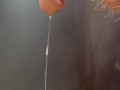 Hairy cock grools long string of precum and leaks pee and bulbourethral fluid down it