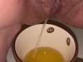 Girl pisses in a coffee cup