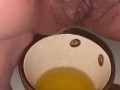 Girl pisses in a coffee cup