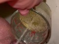 Girl measures her morning piss and overflows the cup