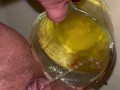 Girl measures her morning piss and overflows the cup