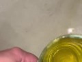 Girl measures her morning piss and overflows the cup