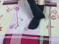 Girl in gray long socks on her legs caresses herself in bed