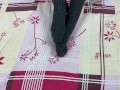 Girl in gray long socks on her legs caresses herself in bed