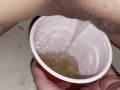 Girl pisses in red solo cup