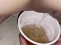 Girl pisses in red solo cup