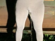 Girl pees in her yoga pants behind dumpster