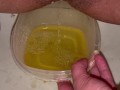 Babe does close up piss in Tupperware container