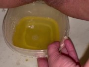 Babe does close up piss in Tupperware container
