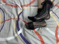 Caressing long legs of girl in black lace socks