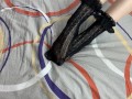 Caressing long legs of girl in black lace socks