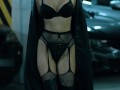 A model with an hourglass figure in long boots, stockings and black gloves seduces me in the parking