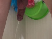 Guy pees in the bathroom rear view