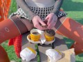 Naked drinking coffee in the park