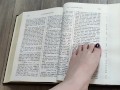Using my long finger toes to flip through the pages of a Bible with my clean barefeet