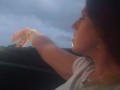 Milf smoking cigarettes while in passenger seat in vehicle